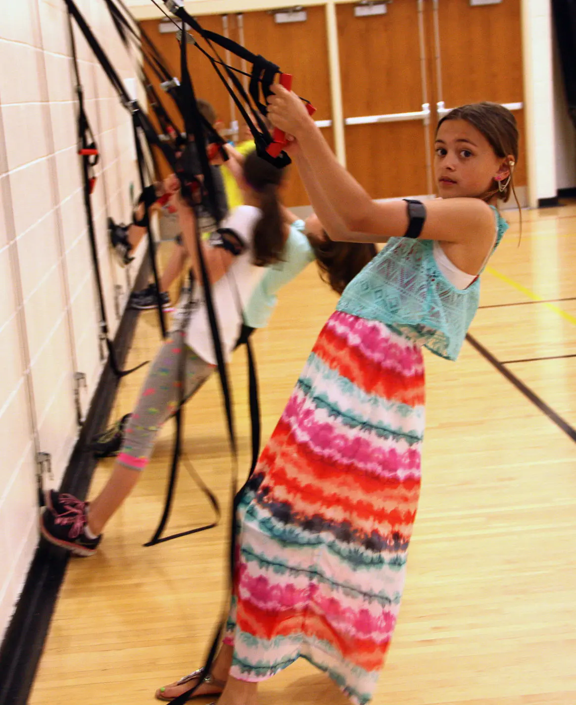 Grand Avenue Elementary student in gym with Heart Zones heart rate monitor
