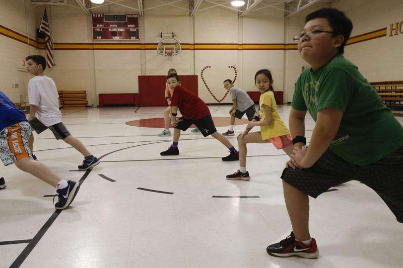 St Matthews students stretching with heart rate monitors