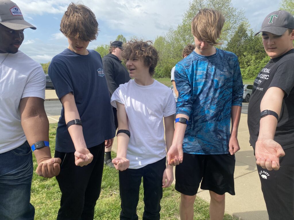 five timberland high school students showing their heart rate sensors